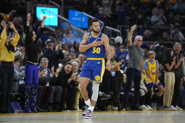 Golden State Warriors guard Stephen Curry celebrates his 3-point basket against the Boston Celtics during the first half of an NBA basketball game in San Francisco, Saturday, Dec. 10, 2022. (AP Photo/Godofredo A. Vásquez)