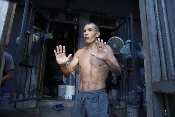 Former Colombian soldier Carlos Guerrero, accused of participating in the assassination of Haitian President Jovenel Moise, speaks with journalists inside the National Penitentiary in Port-au-Prince, Haiti, Sunday, March 3, 2024. (AP Photo/Odelyn Joseph)