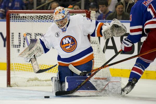 New York Islanders goaltender Ilya Sorokin (30) blocks a shot by New York Rangers center Greg McKegg (14) during the first period of an NHL hockey game, Thursday, March 17, 2022, in New York. (AP Photo/John Minchillo)
