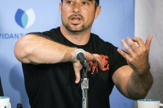 Charlie Winter describes how he grabbed his daughter Paige, 17, by her upper body to get her loose from a shark's grip during a press conference, Friday, June 14, 2019 in Greenville, N.C. (Julia Wall/The News & Observer via AP)
