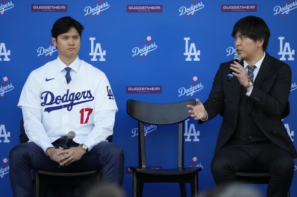 FILE - Los Angeles Dodgers' Shohei Ohtani, left, and interpreter Ippei Mizuhara answer questions during a news conference at Dodger Stadium on Dec. 14, 2023, in Los Angeles. Mizuhara has been fired from the Dodgers following allegations of illegal gambling and theft. (AP Photo/Ashley Landis,File)