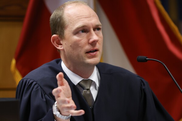 Fulton County Superior Judge Scott McAfee presides in court, Friday, March, 1, 2024, in Atlanta. The hearing is to determine whether Fulton County District Attorney Fani Willis should be removed from the case because of a relationship with Nathan Wade, special prosecutor she hired in the election interference case against former President Donald Trump. (AP Photo/Alex Slitz, Pool)