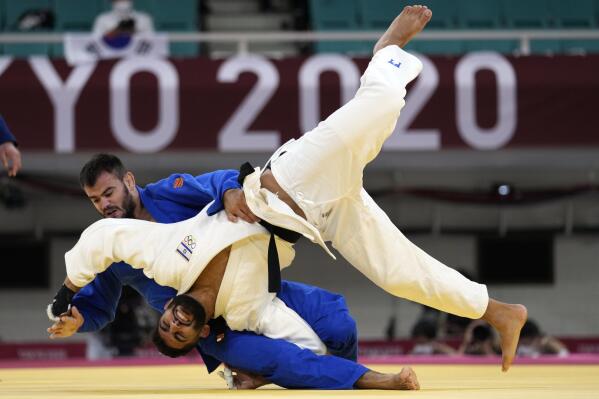Victor Sterpu of Moldova, top, and Tohar Butbul of Israel compete during their men's -73kg round of 16 judo match at the 2020 Summer Olympics in Tokyo, Japan, Monday, July 26, 2021. (AP Photo/Vincent Thian)