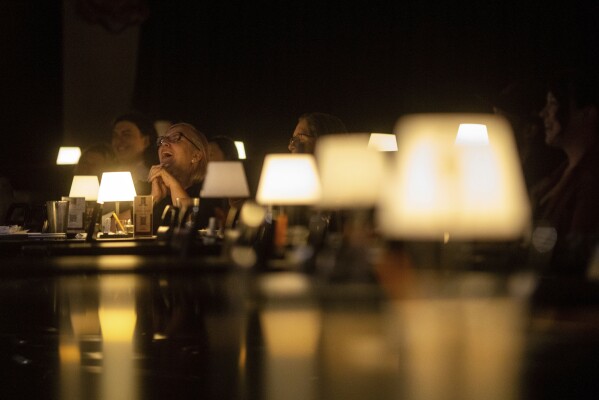Audience members laugh during Stand Up For Climate, a comedy show at Flappers Comedy on Thursday, March 20, 2025, in Burbank, Calif. (AP Photo/Ethan Swope)