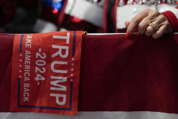 Supporters arrive before Republican presidential candidate former President Donald Trump speaks at a caucus night party in Des Moines, Iowa on Monday. (AP Photo/Andrew Harnik)