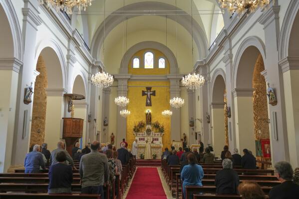 Maronite Catholic faithful attend a service on the Feast Day of St. George in St. George Church in the Maronite village of Kormakitis in the breakaway north of the ethnically divided Cyprus on Wednesday, April 23, 2025. (AP Photo/Petros Karadjias)