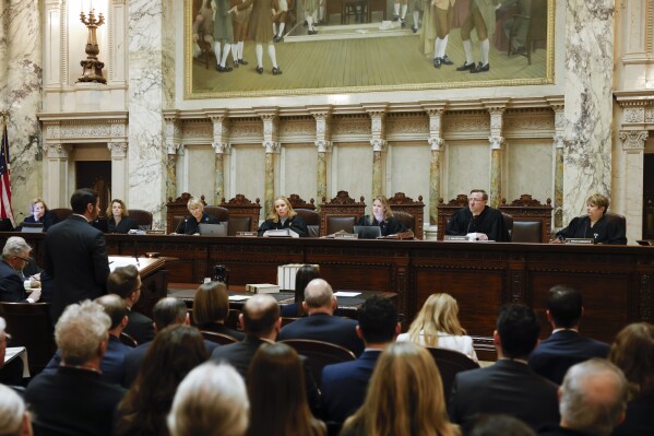 The Wisconsin Supreme Court listens to arguments from Wisconsin Assistant Attorney General Anthony D. Russomanno, who is representing Gov. Tony Evers, in a redistricting hearing at the Wisconsin state Capitol Building in Madison, Wis., on Tuesday, Nov. 21, 2023. (Ruthie Hauge/The Capital Times via AP, Pool)