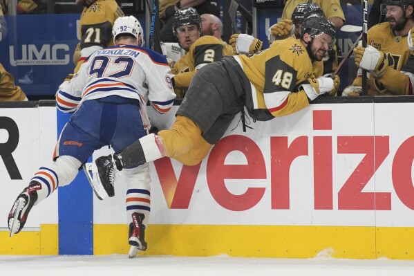 Edmonton Oilers right wing Vasily Podkolzin (92) checks Vegas Golden Knights center Tomas Hertl (48) during the first period of Game 5 of a second-round NHL hockey playoff series Wednesday, May 14, 2025, in Las Vegas. (AP Photo/John Locher)