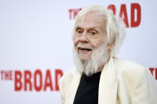 FILE - In this Thursday, Sept. 17, 2015, file photo, artist John Baldessari poses at The Broad museum's opening and inaugural dinner in Los Angeles. Baldessari, who pioneered a new genre of art in the 1970s and in the process helped elevate Los Angeles' status in the art world from that of back-water berg to a center of the conceptual movement, has died at age 88. Baldessari died Thursday at his home in Los Angeles, the artist's representatives at New York's Marian Goodman Gallery, confirmed Monday, Jan. 6, 2020. (Photo by Chris Pizzello/Invision/AP)