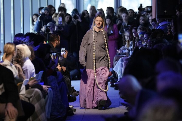 A model wears a creation part of the men's Simon Cracker Fall-Winter 2024-2025 collection, that was presented in Milan, Italy, Sunday, Jan. 14, 2024. (AP Photo/Antonio Calanni).
