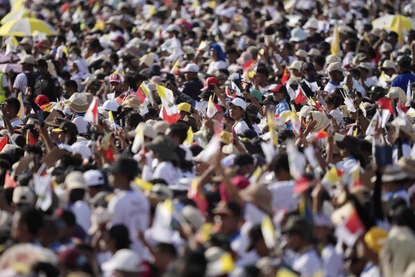 People attend the holy mass lead by Pope Francis at Tacitolu park in Dili, East Timor, Tuesday, Sept. 10, 2024. (AP Photo/Dita Alangkara, Pool)