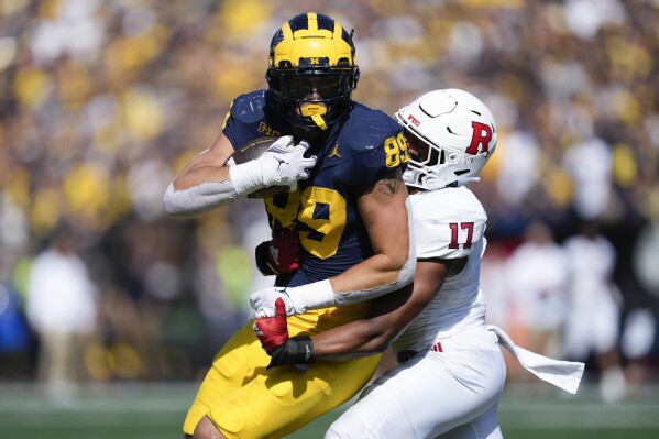 Michigan tight end AJ Barner (89) fights to break the tackle of Rutgers linebacker Deion Jennings (17) in the second half of an NCAA college football game in Ann Arbor, Mich., Saturday, Sept. 23, 2023. (AP Photo/Paul Sancya)