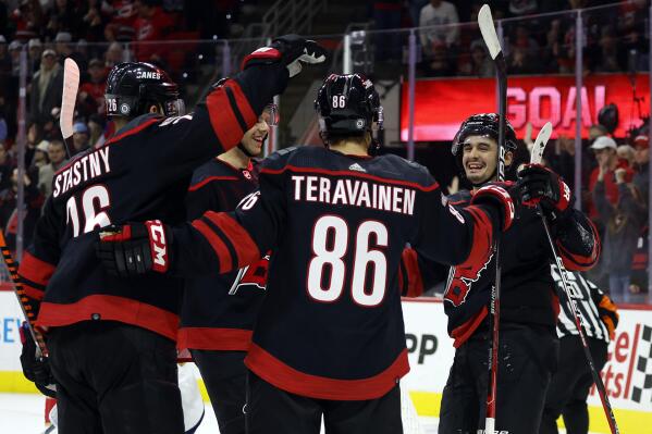 Carolina Hurricanes' Teuvo Teravainen (86) celebrates after his goal with teammates Paul Stastny (26), Jesperi Kotkaniemi, back left, and Seth Jarvis, back right, during the second period of an NHL hockey game against the Florida Panthers in Raleigh, N.C., Friday, Dec. 30, 2022. (AP Photo/Karl B DeBlaker)