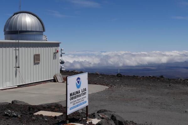 FILE - This 2019 photo provided by NOAA shows the Mauna Loa Atmospheric Baseline Observatory, high atop Hawaii's largest mountain in order to sample well-mixed background air free of local pollution. Mauna Loa’s volcano eruption has temporarily knocked off power to the world’s premier station that measures heat-trapping carbon dioxide in the atmosphere, but officials said that there are hundreds of other carbon dioxide monitoring sites across the globe. (Susan Cobb/NOAA Global Monitoring Laboratory via AP, File)