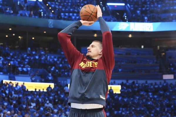 Denver Nuggets center Nikola Jokic warms up before Game 7 in the Western Conference semifinals of the NBA basketball playoffs against the Oklahoma City Thunder, Sunday, May 18, 2025, in Oklahoma City. (AP Photo/Kyle Phillips)