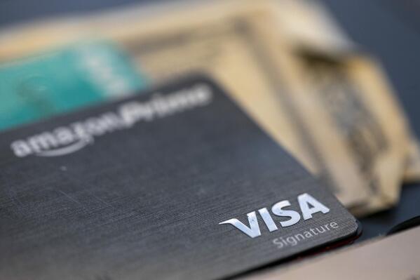 FILE - The Visa logo is seen on a credit card in New Orleans, Aug. 11, 2019. Visa is pausing their decision to start categorizing purchases at gun shops, a significant win for conservative groups and 2nd Amendment advocates who felt that tracking gun shop purchases would inadvertently discriminate against legal firearms purchases. (AP Photo/Jenny Kane, File)
