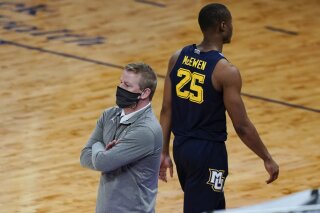 FILE - In this March 10, 2021, file photo, Marquette coach Steve Wojciechowski, left, watches the team play, while Koby McEwen (25) heads to the bench after fouling out of the game during the second half of an NCAA college basketball game against Georgetown in the Big East conference tournament in New York. Marquette fired Wojciechowski on Friday, March 19, after a seven-season tenure in which he went 128-95 but earned no NCAA Tournament victories(AP Photo/Frank Franklin II)