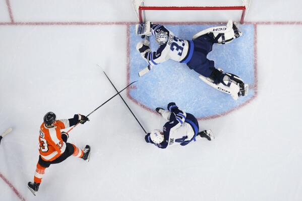 Winnipeg Jets goaltender David Rittich (33) dives to make a save on a shot from Philadelphia Flyers' Kevin Hayes during the second period of an NHL hockey game, Sunday, Jan. 22, 2023, in Philadelphia. (AP Photo/Derik Hamilton)