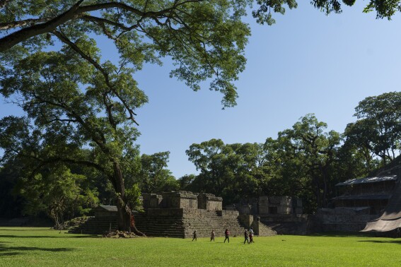 Tourist walk through the Acropolis of Copan, an ancient Maya site in western Honduras, Sunday, Sept. 24, 2023. In Copan, intricate lime sculptures and temples remain intact even after more than 1,000 years exposed to a hot, humid environment. (AP Photo/Moises Castillo)