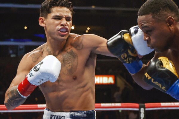 FILE - Ryan Garcia, left, hits Javier Fortuna, right, during a lightweight boxing bout July 16, 2022, in Los Angeles. The fighters seemed just as surprised as fight fans when it was announced that Garcia and Devin Haney, two Californians, would have their April 20, 2024, title fight in New York. But Oscar De La Hoya, Garcia鈥檚 promoter, says bringing the event to Brooklyn is common sense. (AP Photo/Ringo H.W. Chiu, File)