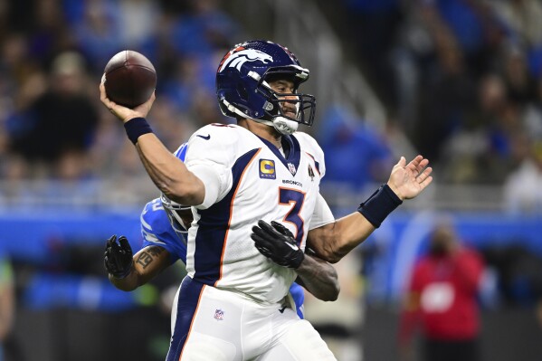 Denver Broncos quarterback Russell Wilson (3) is pressured during the first half of an NFL football game against the Detroit Lions, Saturday, Dec. 16, 2023, in Detroit. (AP Photo/David Dermer)