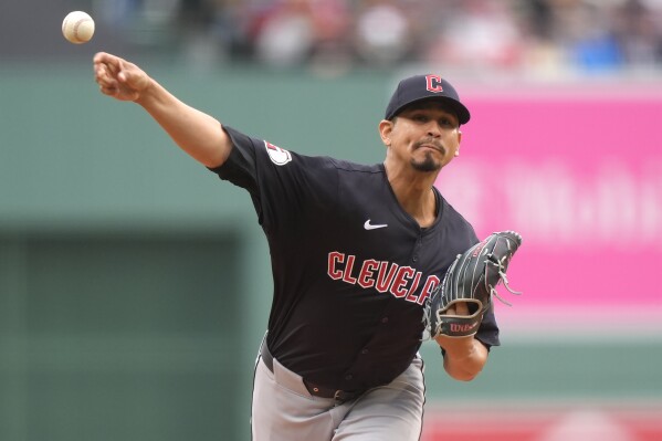 Cleveland Guardians' Carlos Carrasco delivers a pitch to a Boston Red Sox batter in the first inning of a baseball game, Thursday, April 18, 2024, in Boston. (AP Photo/Steven Senne)