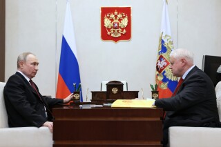 FILE - Russian President Vladimir Putin, left, listens to Sergey Mironov, 70, the leader of political party A Just Russia in Moscow, Russia, on Feb. 14, 2023. A Russian lawmaker and staunch supporter of President Vladimir Putin, Mironov has denied media allegations that he adopted a 2-year-old girl who was seized from a Ukrainian children's home and changed her name in Russia. (Mikhail Metzel, Sputnik, Kremlin Pool Photo via AP, File)