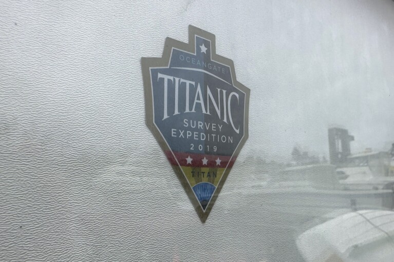 FILE - The logo for an OceanGate Expeditions 2019 Titanic expedition is seen on a marine industrial warehouse office door in Everett, Wash., Tuesday, June 20, 2023. Rescuers are racing against time to find the missing submersible carrying five people, who were reported overdue Sunday night. (AP Photo/Ed Komenda, File)