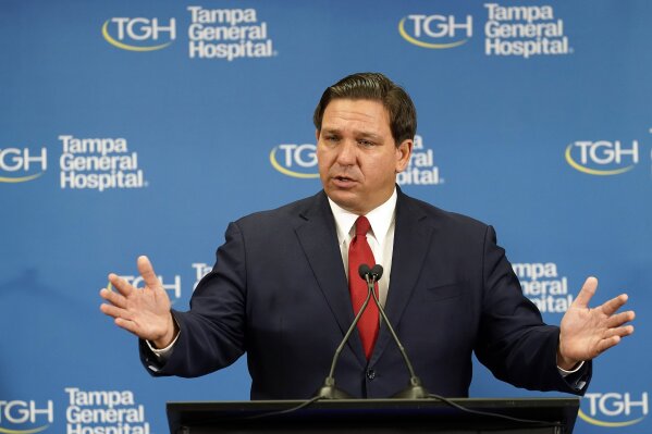 FILE - In this Dec. 14, 2020, file photo Florida Gov. Ron DeSantis speaks to the media after watching the Pfizer-BioNTech COVID-19 vaccine delivered at Tampa General Hospital in Tampa, Fla. DeSantis on Friday, Feb. 19, 2021, proposed an array of voting changes, while state lawmakers have introduced legislation that makes it harder to vote by mail. To explain the efforts, Florida Republicans point not to evidence of problems but to the potential for voter fraud and suspicion about the process (AP Photo/Chris O'Meara, File)
