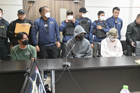 From left to right in front, Suwannahong Promkanajarn, Akarawit Jaithong and Piyabut Pienpitak attend a press conference in Bangkok, Thailand, Thursday, Oct. 5, 2023. Thai police said they have arrested three men for selling illegal guns and bullets in connection to the shooting at a Bangkok's upscale mall which killed two people earlier this week. (AP Photo/Surat Sappakun)