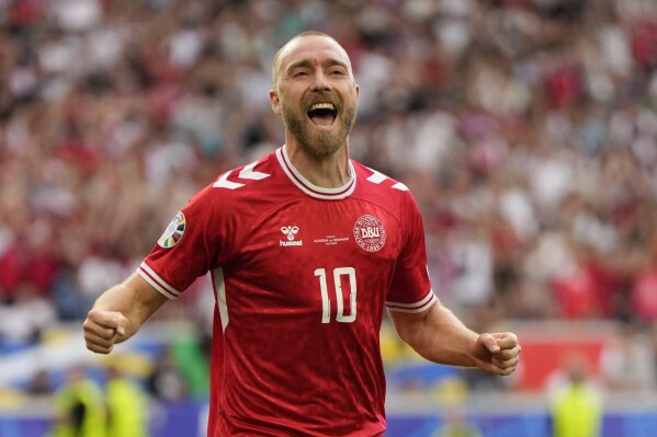 Denmark's Christian Eriksen celebrates after scoring the opening goal of the game during a Group C match between Slovenia and Denmark at the Euro 2024 soccer tournament in Stuttgart, Germany, Sunday, June 16, 2024. (AP Photo/Matthias Schrader)