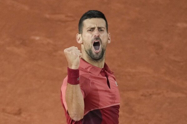 Serbia's Novak Djokovic clenches his fist after scoring a point against France's Pierre-Hugues Herbert during their first round match of the French Open tennis tournament at the Roland Garros stadium in Paris, Tuesday, May 28, 2024. (AP Photo/Christophe Ena)