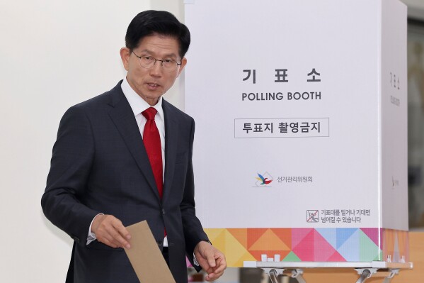 South Korean People Power Party's presidential candidate Kim Moon Soo exits out to cast his early vote for the June 3 presidential election at a polling station in Incheon, South Korea, Thursday, May 29, 2025. (Ryu Young-seok/Yonhap via AP)