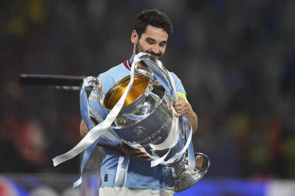 Manchester City's Ilkay Gundogan holds the trophy after the Champions League final soccer match between Manchester City and Inter Milan at the Ataturk Olympic Stadium in Istanbul, Turkey, Sunday, June 11, 2023. (AP Photo/Emrah Gurel)