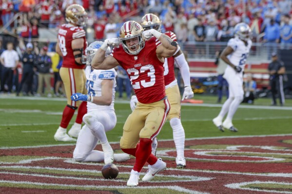 San Francisco 49ers' running back Christian McCaffrey (23) reacts after scoring a touchdown against the Detroit Lions in the second quarter of the NFC Championship NFL football game in Santa Clara, Calif., Sunday, Jan. 28, 2024. (Carlos Avila Gonzalez/San Francisco Chronicle via AP)