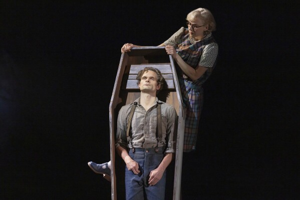 This image released by DKC/O+M shows Andrew Durand, center, with Julia Knitel, during a performance of “Dead Outlaw.