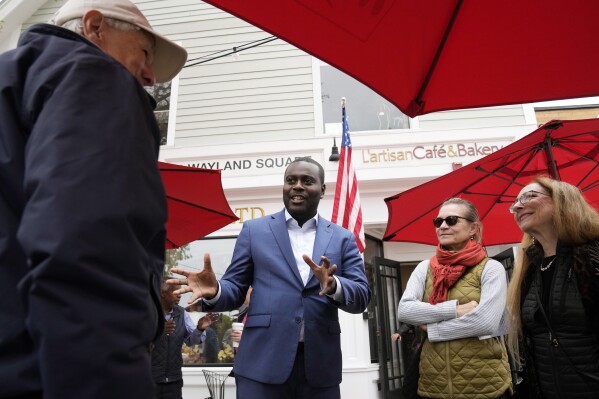 Gabe Amo, Rhode Island Democratic candidate for the U.S. House, center, greets people during a campaign stop at a cafe, Monday, Nov. 6, 2023, in Providence, R.I. Amo and Republican Gerry Leonard face off in a special congressional election in Rhode Island on Tuesday, Nov. 7, to complete the term of former Democratic U.S. Rep. David Cicilline. (AP Photo/Steven Senne)