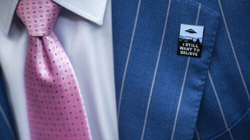 An audience member wears a UFO pin during a House Oversight and Accountability subcommittee hearing on UFOs, Wednesday, July 26, 2023, on Capitol Hill in Washington. (AP Photo/Nathan Howard)