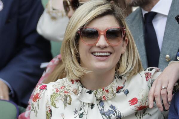 FILE - In this file photo dated Saturday, July 13, 2019, actress Jodie Whittaker sits in the Royal Box on Centre Court to watch the women's singles final match between Serena Williams of the United States and Romania's Simona Halep on day twelve of the Wimbledon Tennis Championships in London.  The BBC said Thursday July 29, 2021, that star Jodie Whittaker will leave the Doctor Who science fiction series next year, but before leaving Whittaker will appear in a new six-episode series in 2021 and three special episodes in 2022.(AP Photo/Ben Curtis, FILE)
