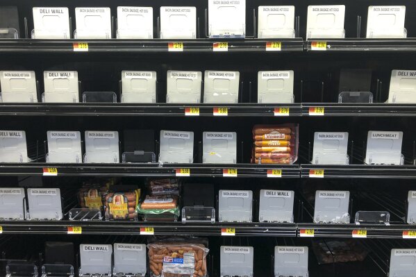 Shelves of hot dogs are nearly empty at a Walmart in Warrington, Pa., Tuesday, March 17, 2020. Concerns over the new coronavirus have led to consumer panic buying of grocery staples in stores across the country. (AP Photo/Matt Rourke)