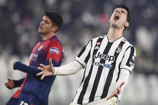 Juventus' Alvaro Morata, right, reacts, during the Italian Serie a soccer match between Juventus and Cagliari at the Allianz Stadium in Turin, Italy, Tuesday, Dec. 21, 2021. (Fabio Ferrari/LaPresse via AP)