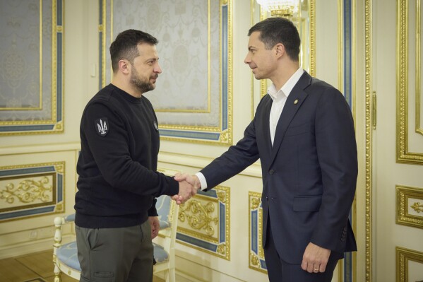 In this photo provided by the Ukrainian presidential press office, Ukrainian President Volodymyr Zelensky, left, shakes the hand of U.S. Transportation Secretary Pete Buttigieg in Kiev, Ukraine, Wednesday, Nov. 8, 2023.  (Ukrainian Presidential Press Office via AP)