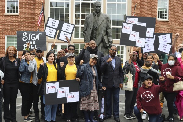 Supporters of a Maryland measure to create a commission to study potential reparations for slavery rally on Friday, May 9, 2025 in Annapolis, Md., next to a statute of former Supreme Court Justice Thurgood Marshall. (AP Photo/Brian Witte)
