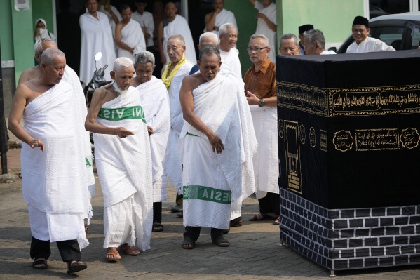 Husin bin Nisan, second left, walks with other worshippers to circle a mock Kaaba during a hajj rehearsal in Tangerang, Indonesia, Monday, May 15, 2023. (AP Photo/Achmad Ibrahim)