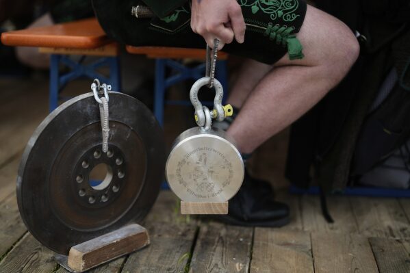 A competitor warms up for his bout while he try to pull the opponent over the table at the German Championships in Fingerhakeln or finger wrestling, in Pang, near Rosenheim, Germany, Sunday, April 27, 2025. (AP Photo/Matthias Schrader)