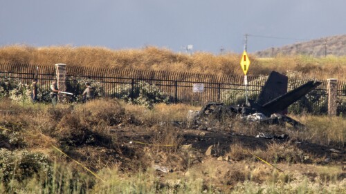 Charred remains of a Cessna lie near the landing approach at French Valley Airport, in Murrieta, Calif., Saturday, July 8, 2023. The Los Angeles Times reports that, according to CalFire, six people died in the crash. (Irfan Khan/Los Angeles Times via AP)