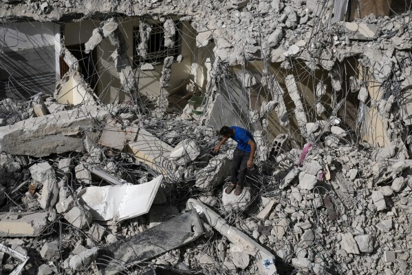 A Palestinian man inspects the damage to a building after Israeli forces raided the West Bank city of Jenin, Thursday, May 23, 2024. (AP Photo/Majdi Mohammed)