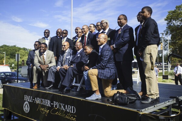 FILE - In this Wednesday, Sept. 27, 2017 photo, older and newer generations of Alpha Phi Alpha fraternity pose for a photograph during the Hall-Archer-Pickard Naming Celebration at Western Michigan University in Kalamazoo, Mich. The oldest historically Black collegiate fraternity in the U.S. says it is relocating a planned convention in two years from Florida because of what it described as Gov. Ron DeSantis' administration's “harmful, racist and insensitive” policies towards African Americans. (Kaytie Boomer/Kalamazoo Gazette-MLive Media Group via AP)