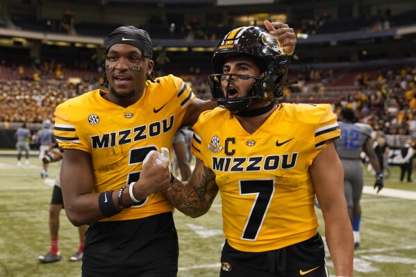 Missouri wide receiver Luther Burden III, left, and running back Cody Schrader celebrate a 34-27 victory over Memphis in an NCAA college football game Saturday, Sept. 23, 2023, in St. Louis. (AP Photo/Jeff Roberson)