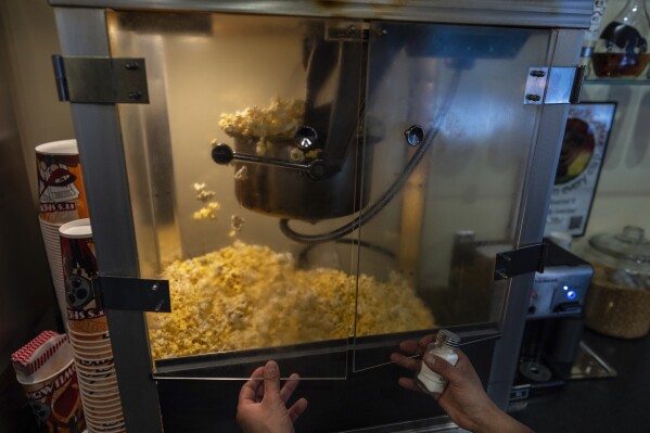 Popcorn pops for the 7 p.m. showing of Raising Arizona at the Littel Art Theatre on Thursday, May 16, 2024, in Yellow Springs, Ohio. When the Little Art Theatre set out to land a $100,000 grant to fund a stylish new marquee, the cozy arthouse theater had some talented help. Oscar-winning documentarian Steve Bognar lives in Yellow Springs, the bohemian Ohio town where the theater's a downtown fixture. (AP Photo/Carolyn Kaster)